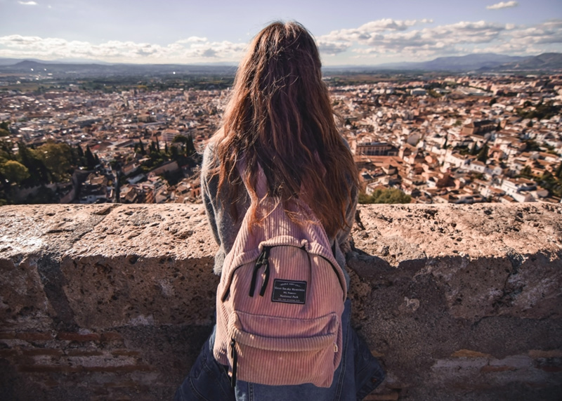 woman with backpack looking out