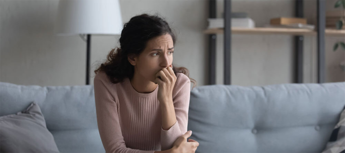 worried woman on the couch