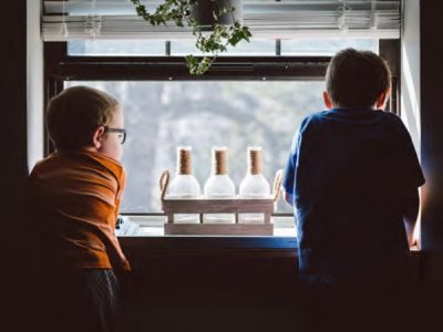 two little kids looking out the window