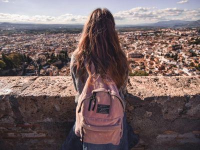 woman with backpack looking out